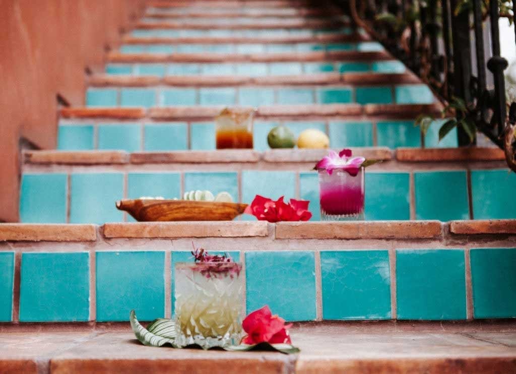 Photoshoot on a turquoise stair with tropical cocktails from Snake Oil Cocktail Company