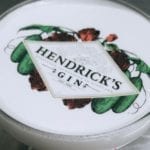 Cocktail in a Coupe Glass with Hendrick's Gin Logo on top with ingredients