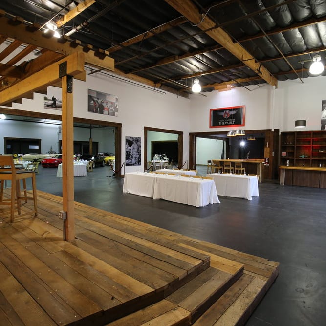 Open indoor event space with a stage, sd creative space.